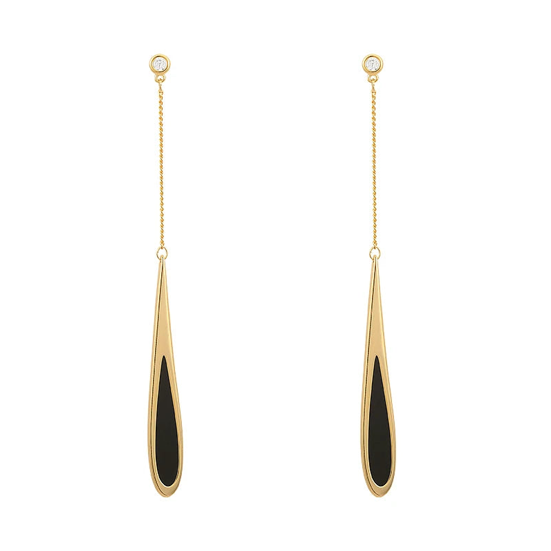Gold and black drop earrings on a white background