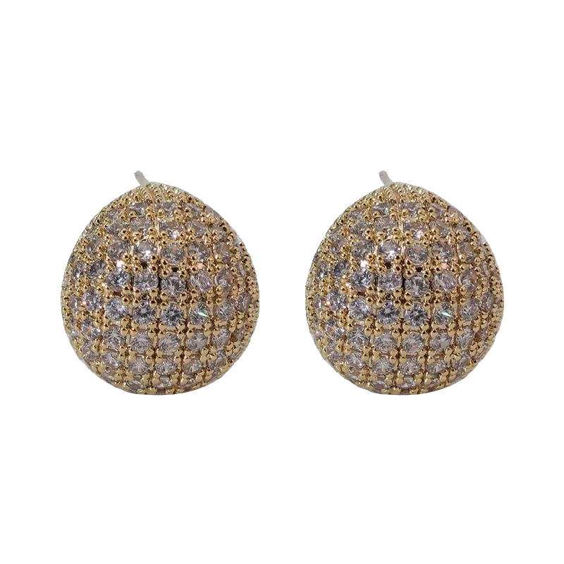 Gold and silver spherical earrings on a white background