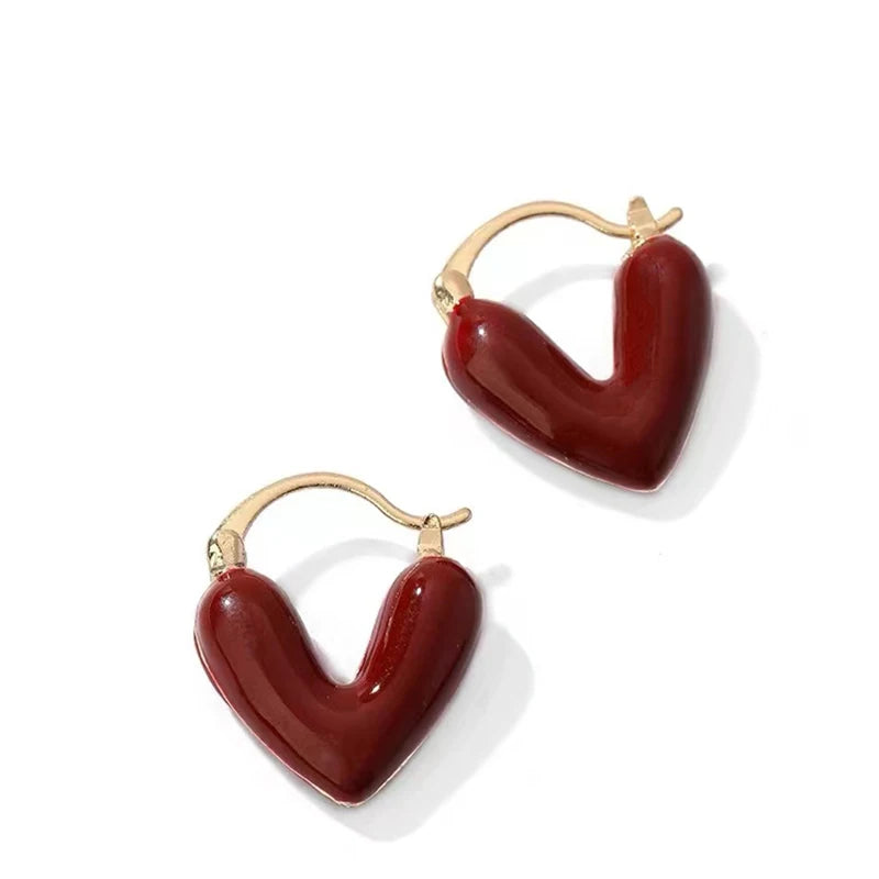 Heart-shaped earrings with gold hooks on a white background