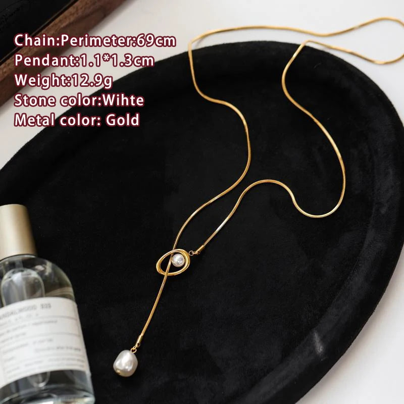 Gold necklace with a pearl pendant on a black surface, with product details overlayed.