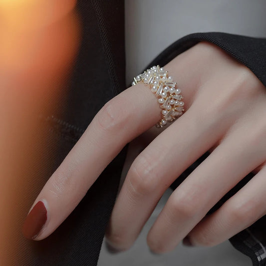 Close-up of a hand wearing a diamond ring with a blurred background