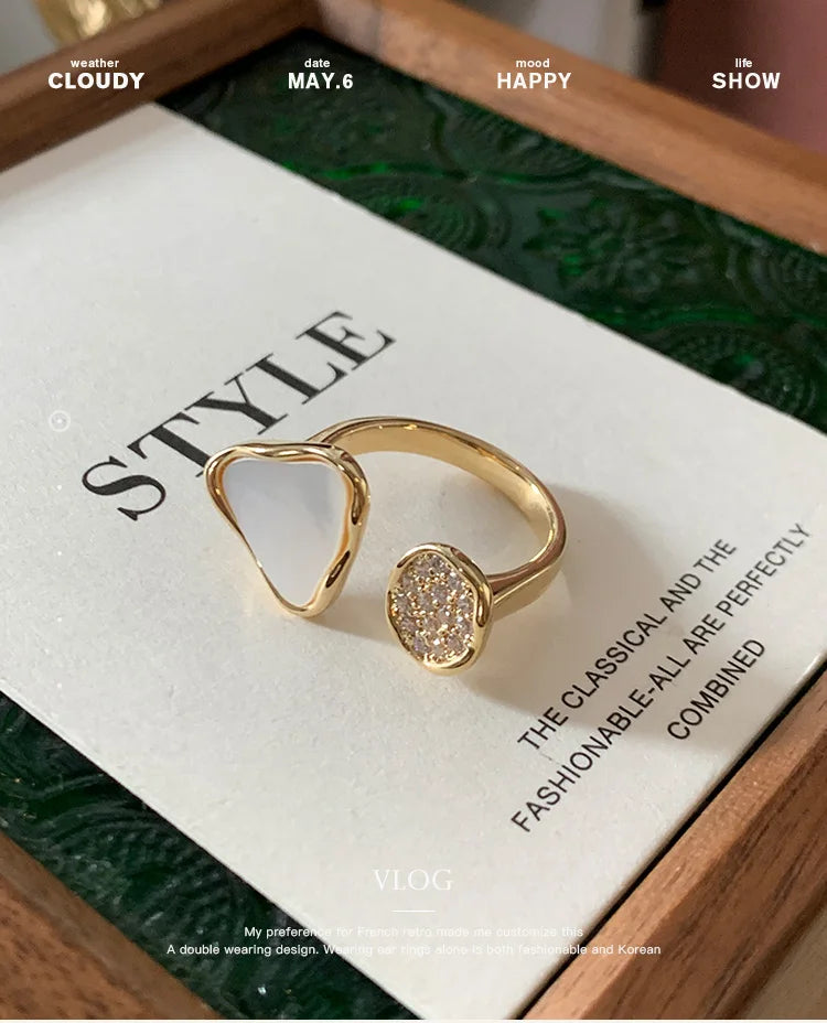 Gold ring on a magazine with text and a wooden surface