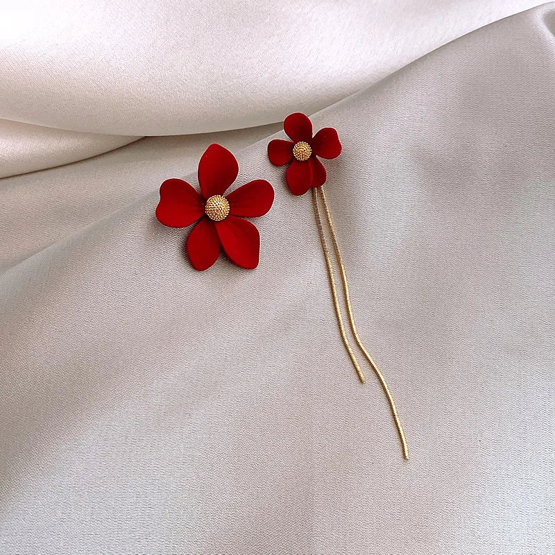 Red flower-shaped hairpins on a beige fabric background