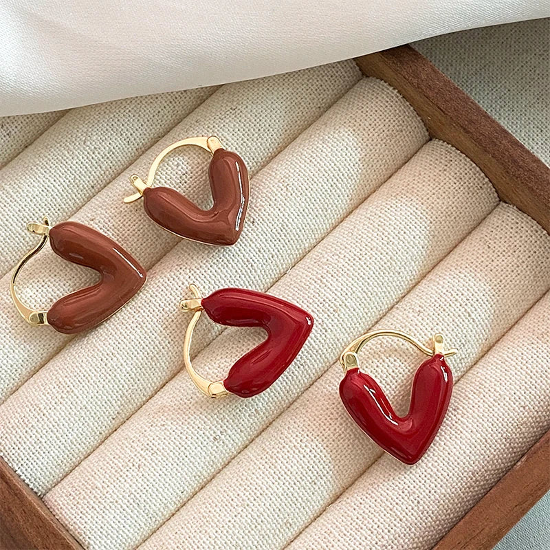 Heart-shaped earrings on a textured surface