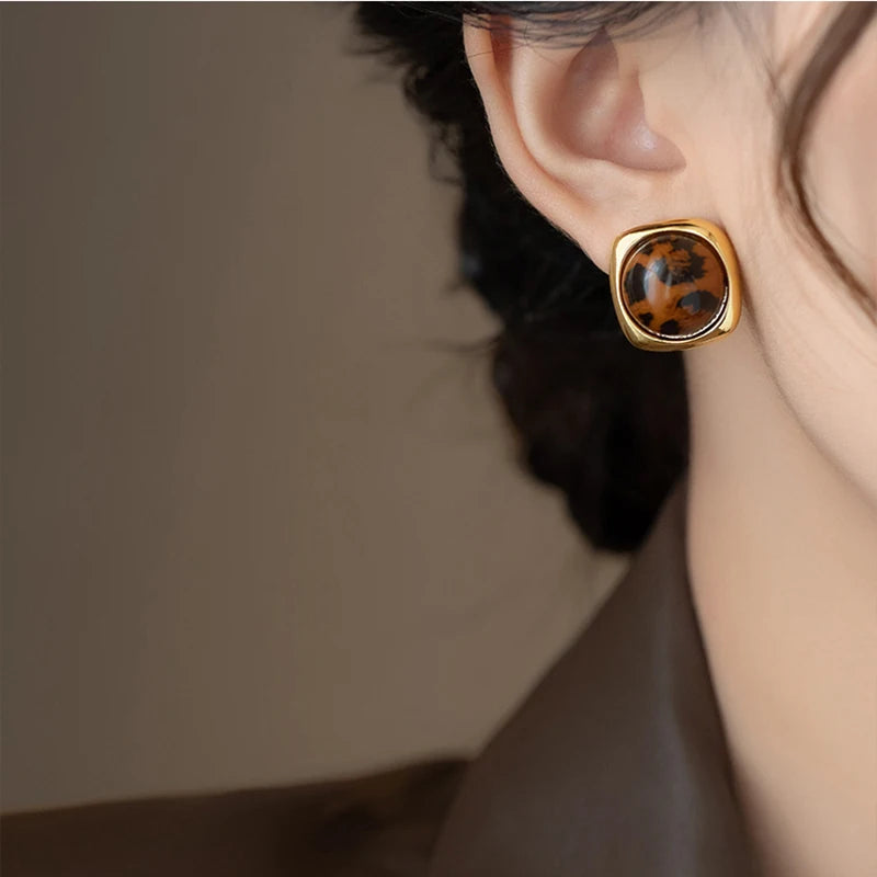 Earring with leopard print design on a blurred background